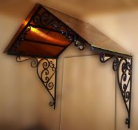 Двухсткатный кованый козырек